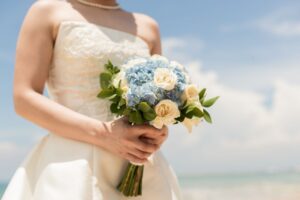 a woman holding a flower bucket as a bride